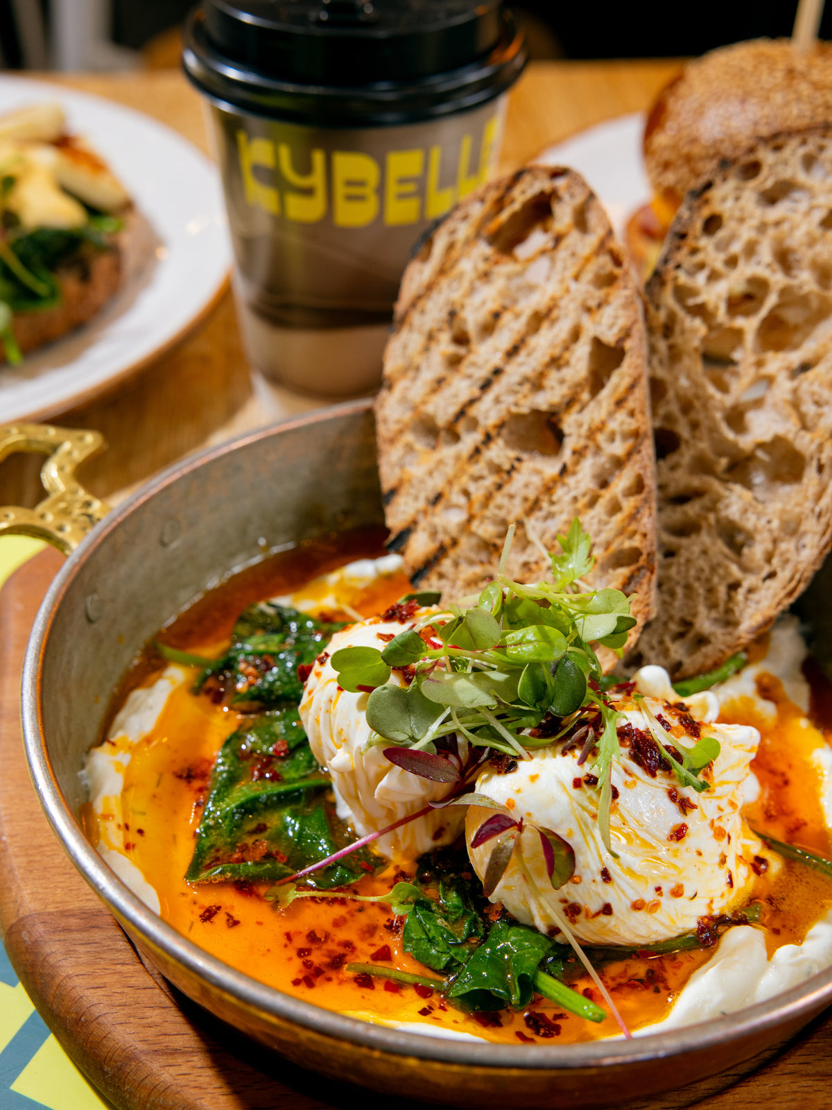 Çılbır Turkish eggs — poached eggs over garlicky yogurt with chilli butter and sourdough at Kybelle Café, Shoreditch